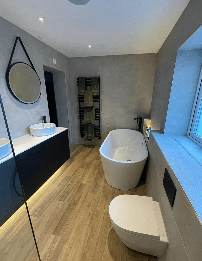Cloakroom with a vanity unit, mirror and heated towel rail