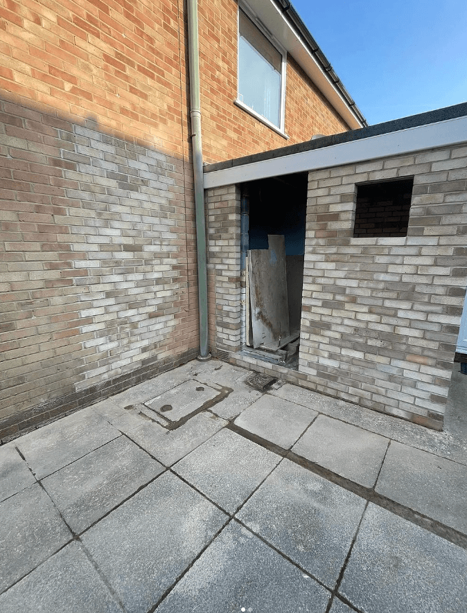 Hallway with a composite front door and an oak-effect floor