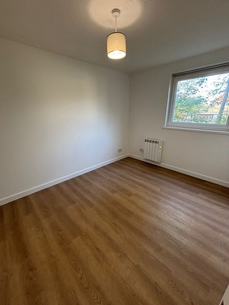 Hot tub installed in a garden room with a panelled ceiling and inset lighting