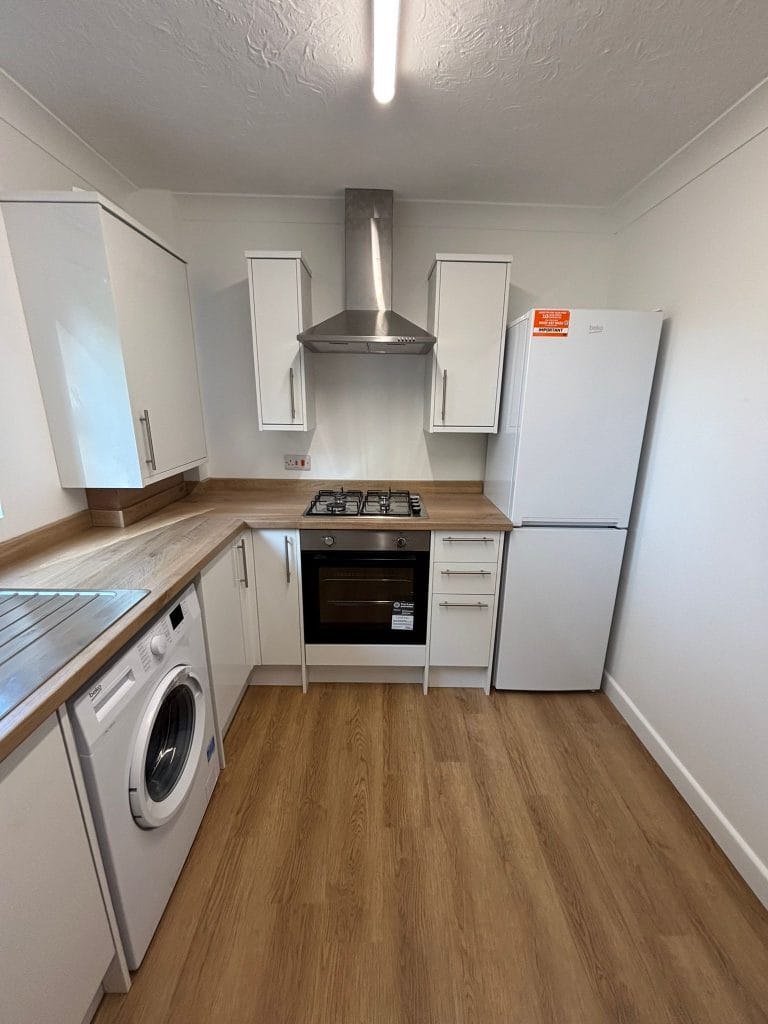 Utility space with a wall cupboard and an appliance