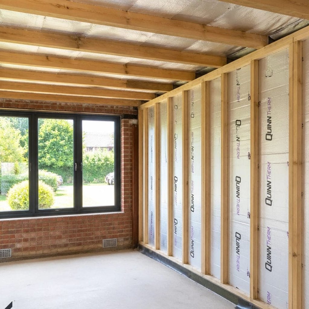 Screeded floor in a room under construction with insulated stud walls